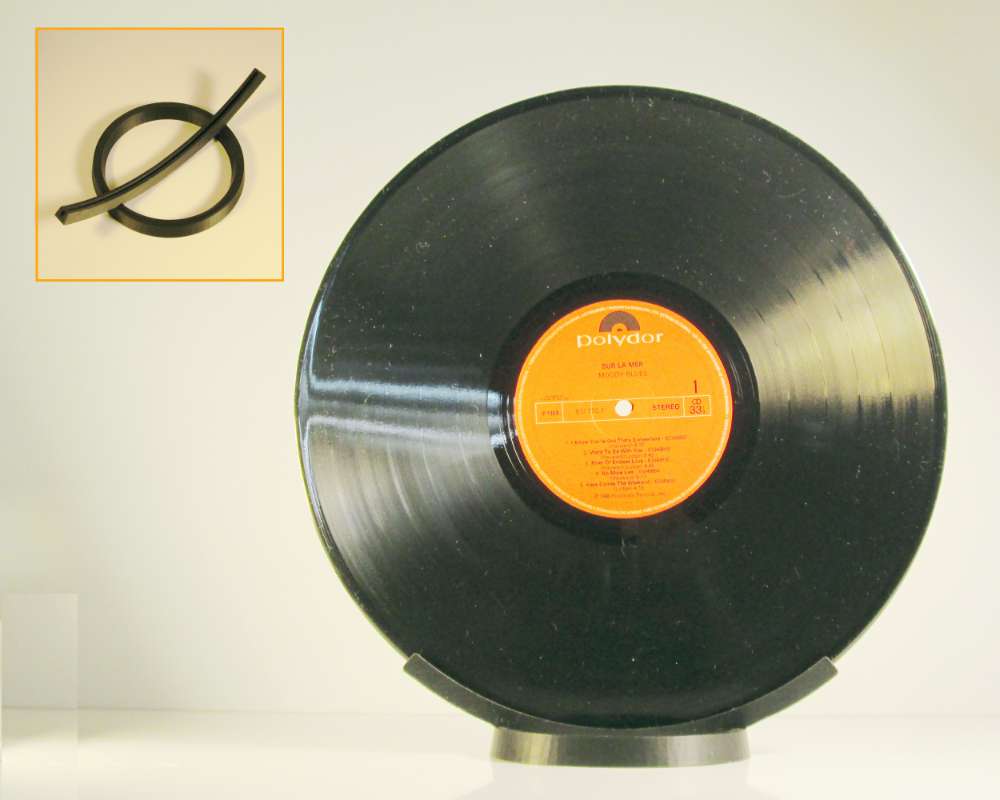 a 3D printed black stand holding one vinyl record vertically.