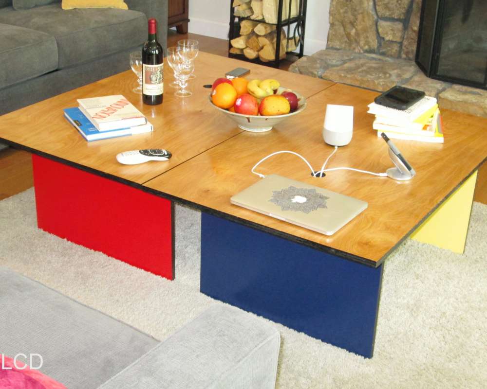 a modern colorful coffee table with holes for passing charging cables for electronic gadgets