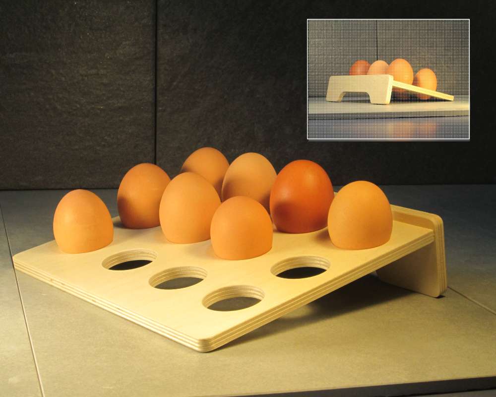 a leaning wood tray with holes holding brown eggs