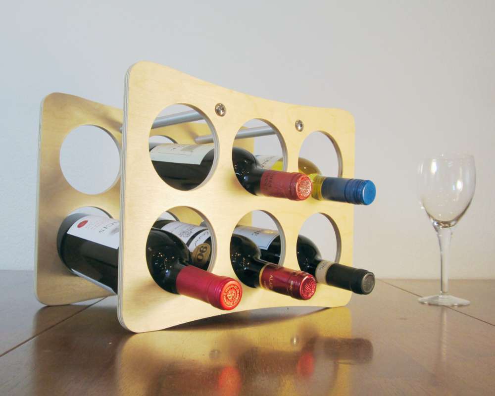 a modern lightweight wood wine rack with six holes for holding wine bottles