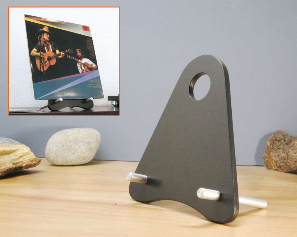 a leaning black stand for holding vinyl  record sleeves