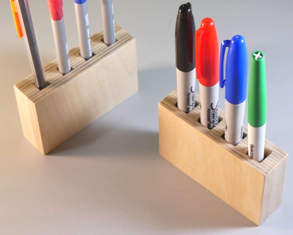 rectangular pen holder made from wood with square holes for pens and pencils